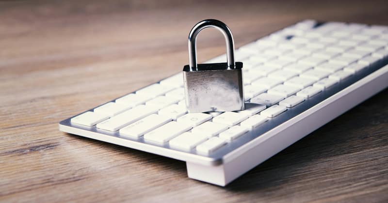 A padlock sitting on a computer keyboard